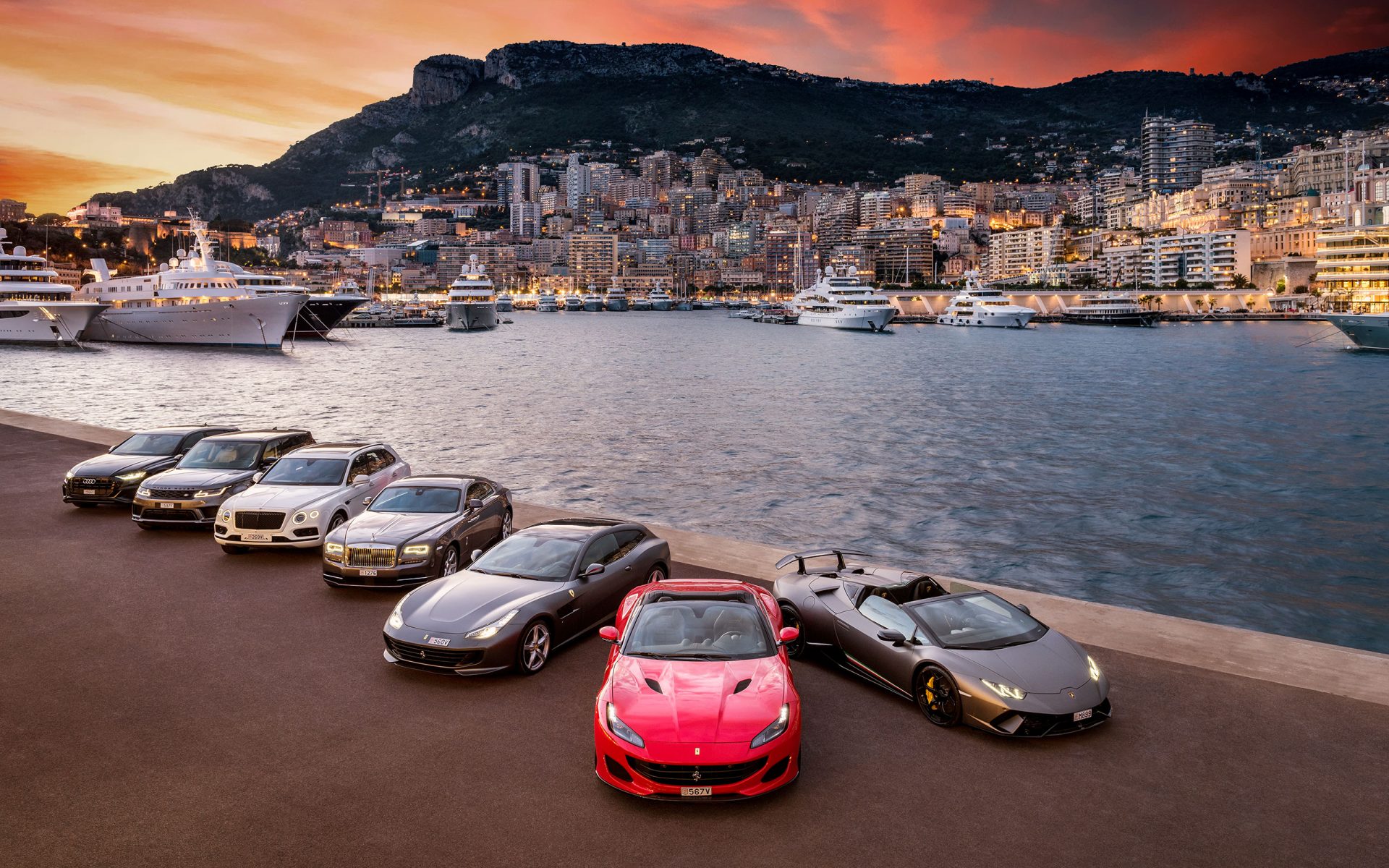 A fleet of exotics gathered on the Monaco harbourfront at sunset